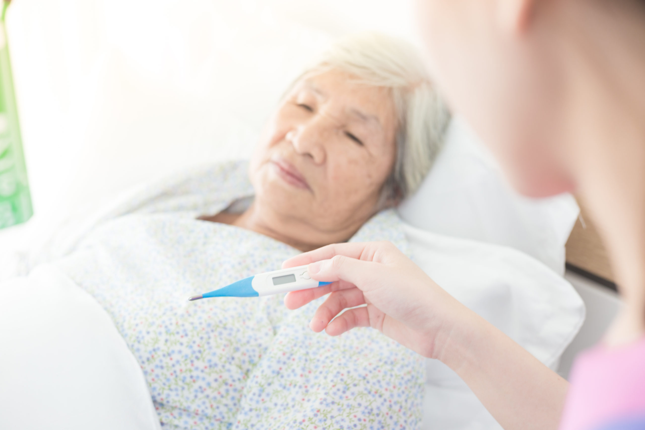 Nurse Taking Elderly Patients Temperature